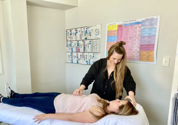 Janette performing a Kinesiology technique on a client laying down