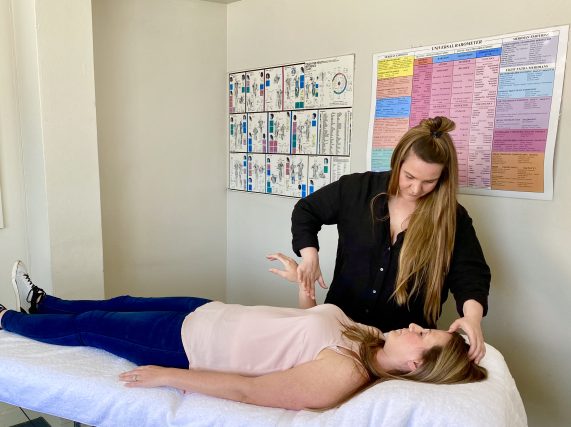 Janette using Muscle Testing techniques to find where stress is being held in the body