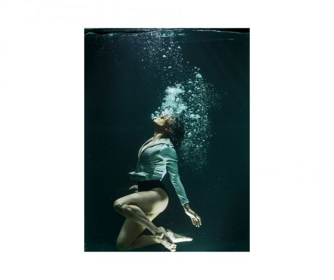 The affect of stress on breathing patterns. A young woman exhales a stream of bubbles underwater